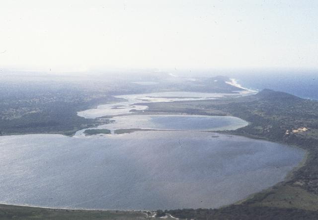 The rock reef in the surf zone which controls the position of the mouth can be clearly seen. Also of note is the flood-tidal delta.